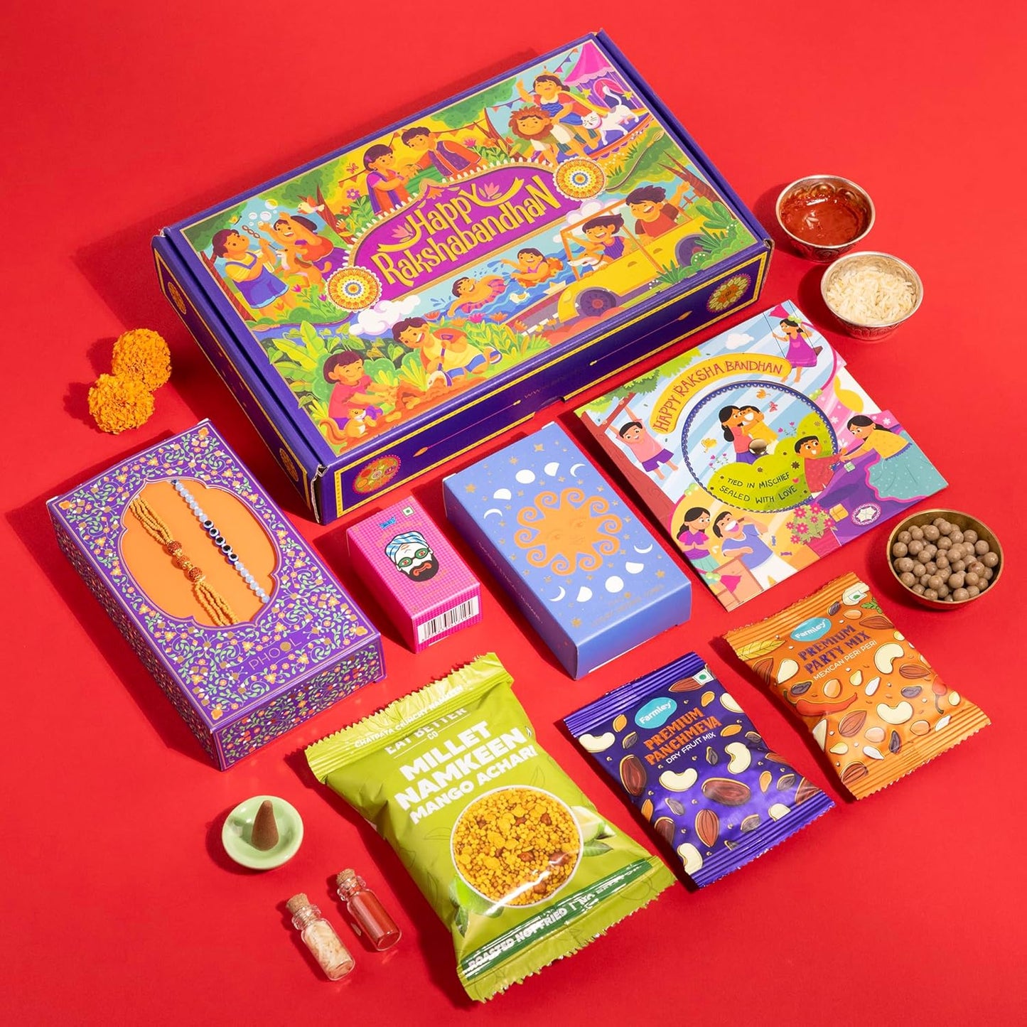 9-in-1 Rakhi Gift Box for Brother & Bhabhi | Combo of 2 Rakhis (Rudraksha & Ocean Gaze) | Farmley Dry Fruit Mix, Party Mix | Eat Better Millet Namkeen | Guru Chela Mouth Freshener | Greeting Card